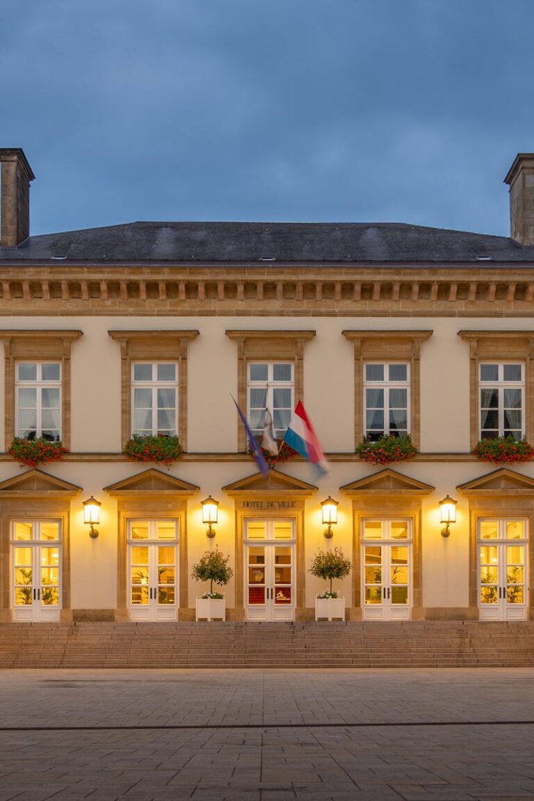 Illuminated historic building in Luxembourg City during blue hour, showcasing classic European architecture.