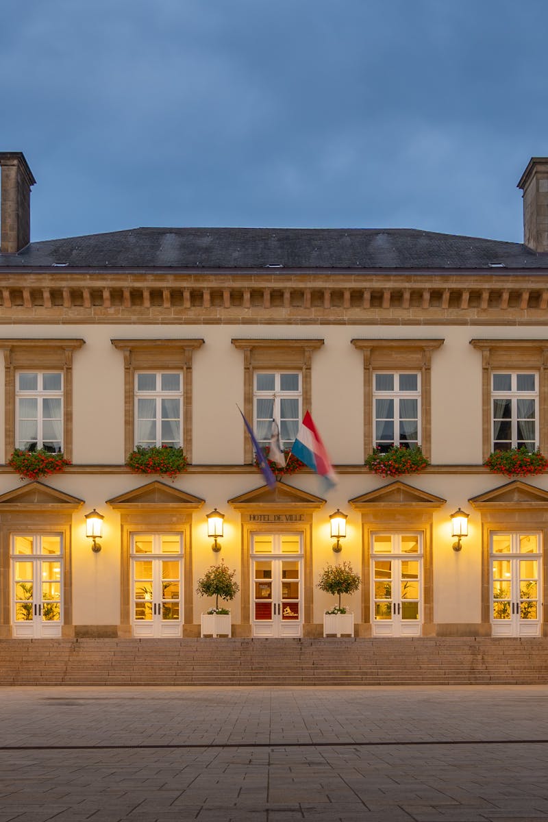 Illuminated historic building in Luxembourg City during blue hour, showcasing classic European architecture.